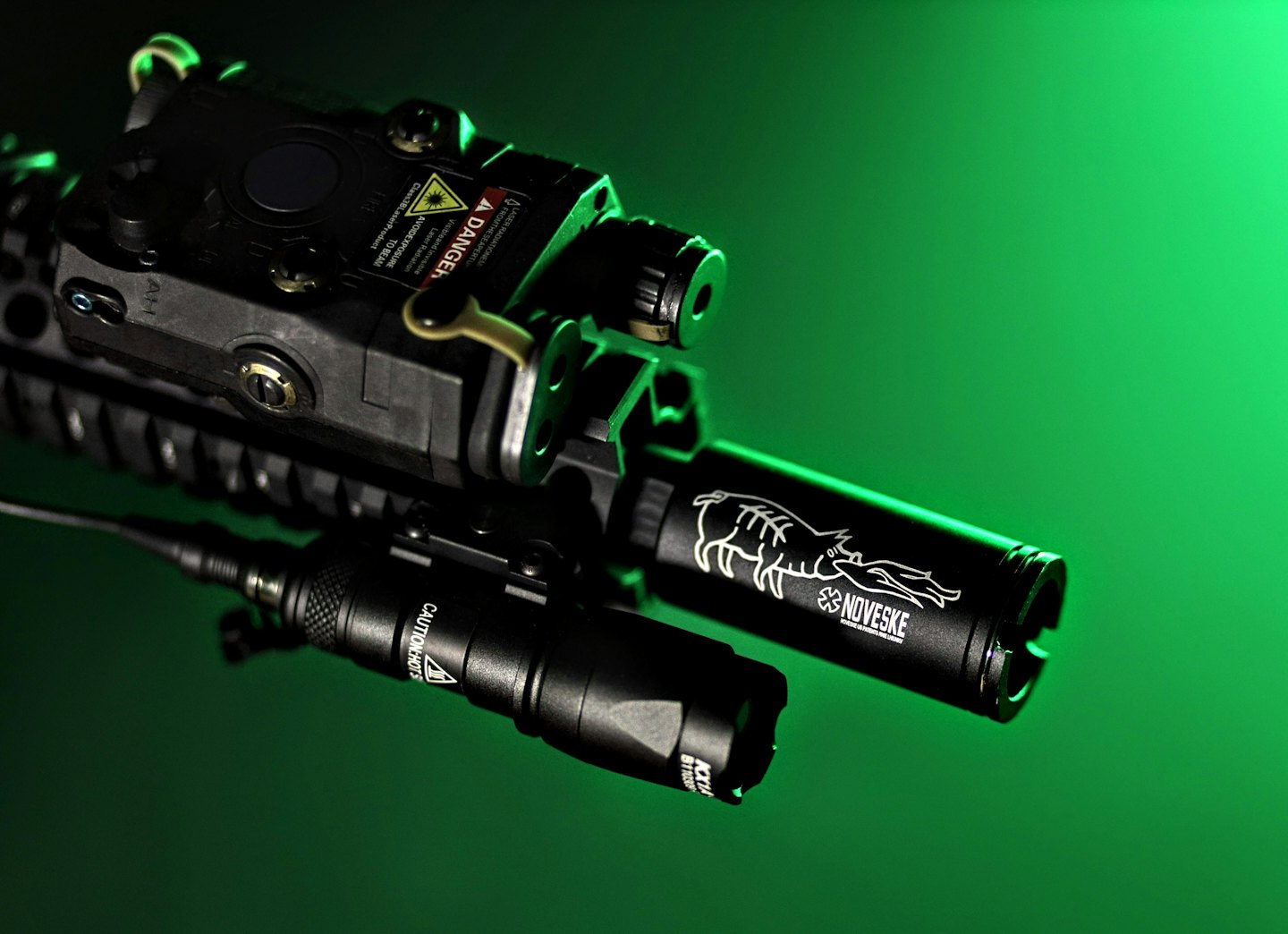 Tactical firearm attachments including a laser module and flashlight.