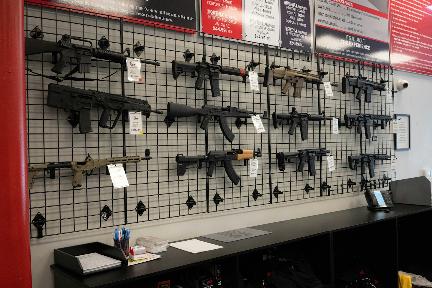 Guns and ammo displayed on a wall in a gun store.